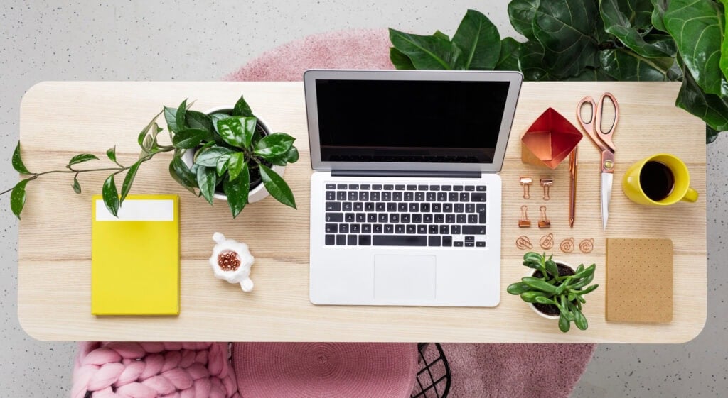 picture of laptop on a desk for the article 10 Monthly Bills You Can Negotiate Today